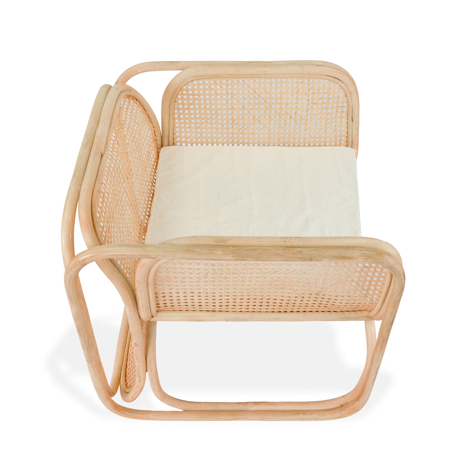 Rattan chair with a white cushion on a white background