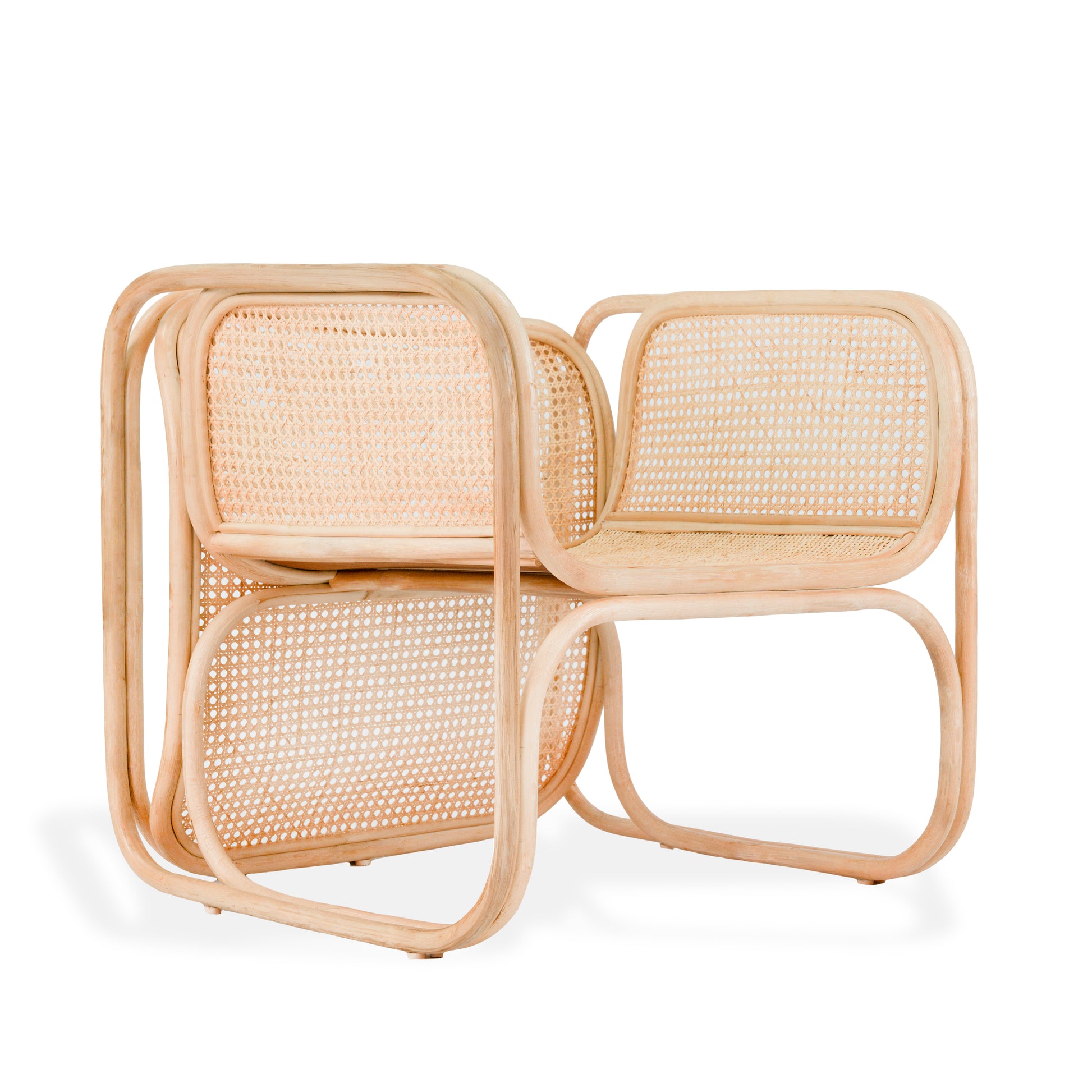 Rattan chair with a white cushion on a white background