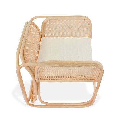 Rattan chair with a white cushion on a white background